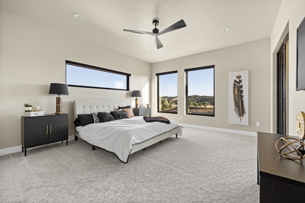 Staged primary bedroom in a TNT built home with Black Hills views